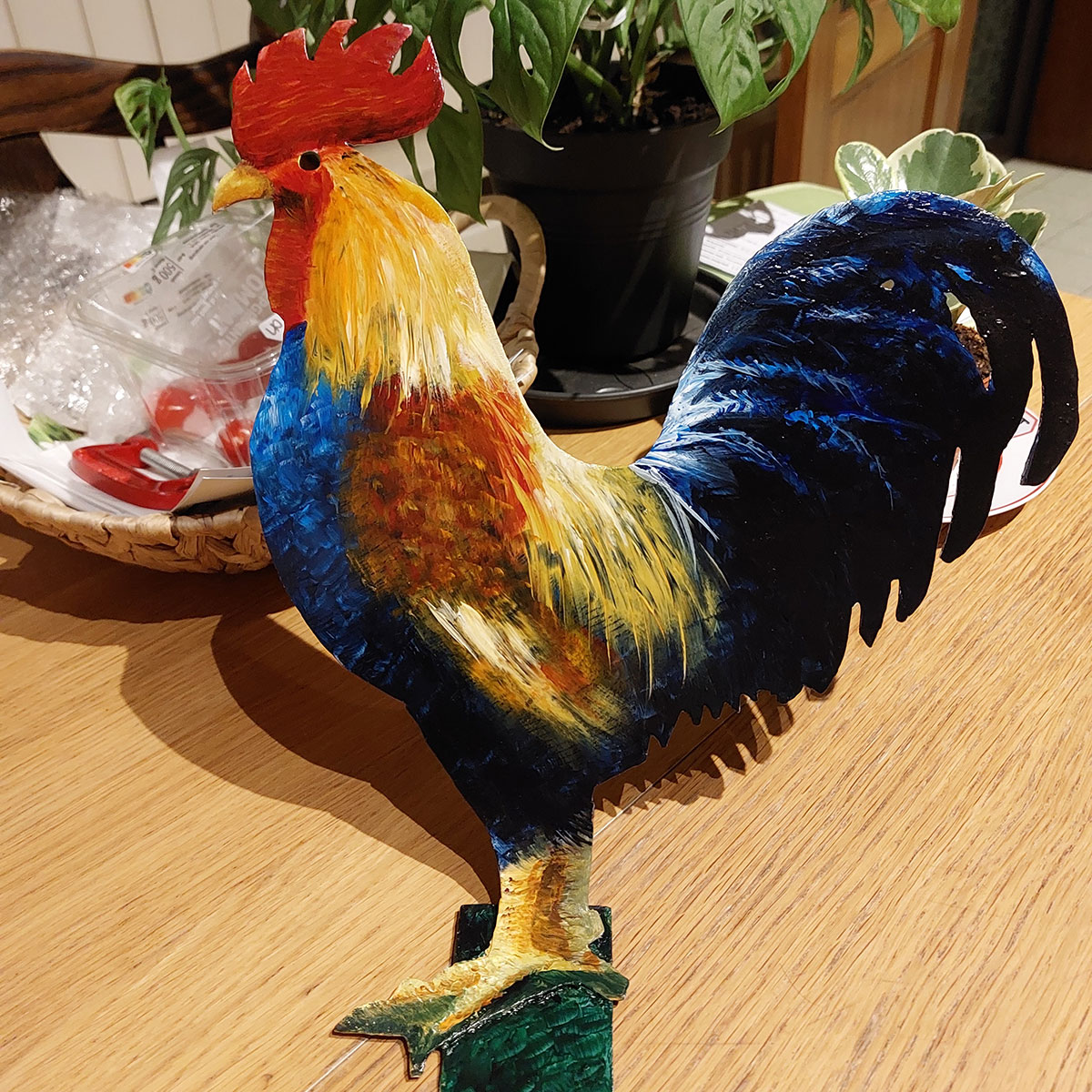 painting of a red and blue rooster on metal plate
