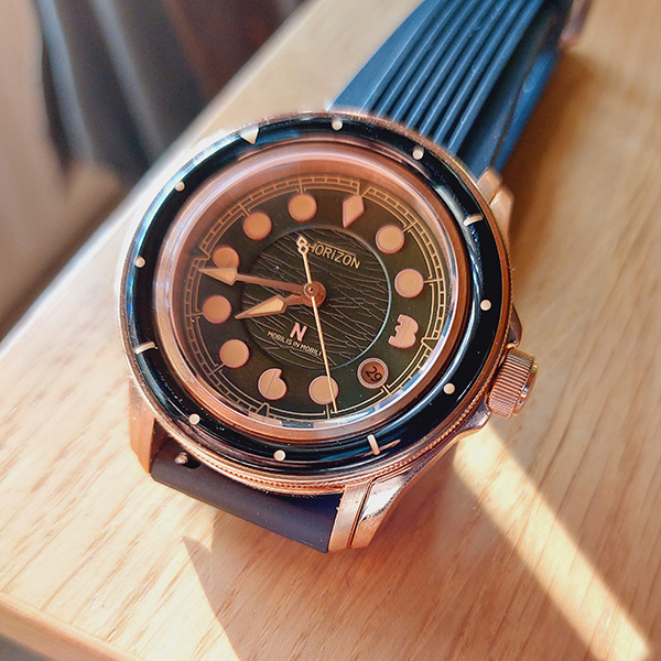 Bronze diving watch with green dial, black diving bezel and round hour markers