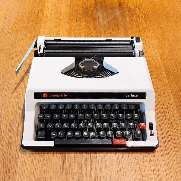 photo of an Olympiette typewriter on a wooden table