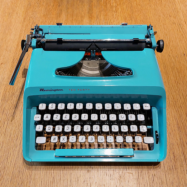 photo of an Olympiette typewriter on a wooden table
