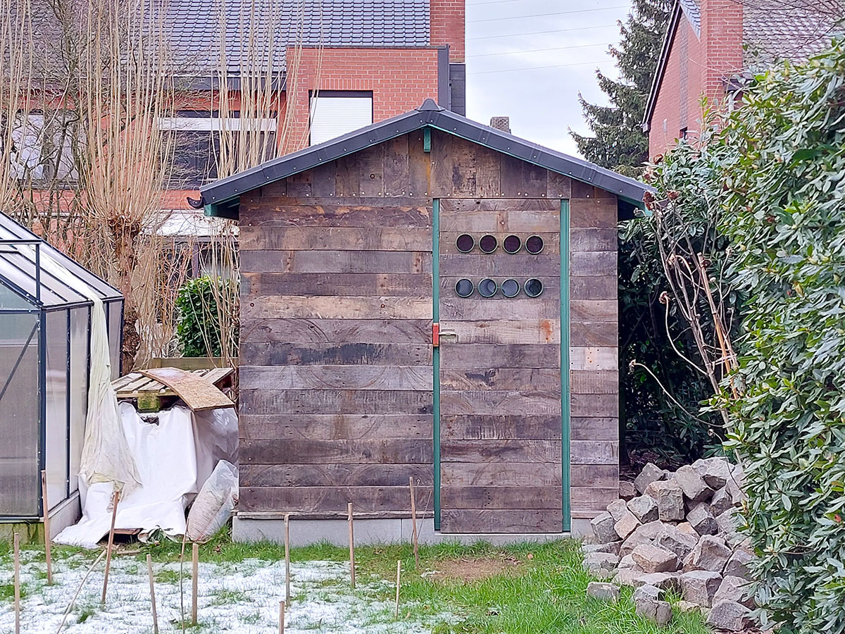 front view of a wooden garden shed in the back garden