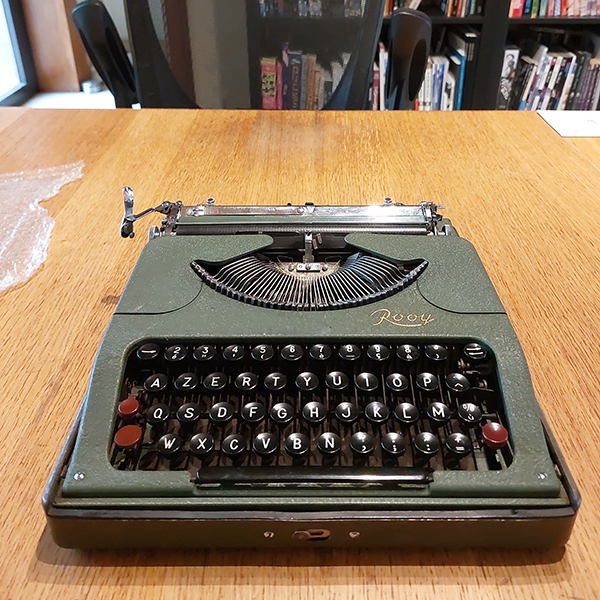 a Van Rooy typewriter on a wooden table